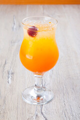 summer cocktail with ice on wooden background