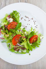 salad with herbs and tomatoes on a plate
