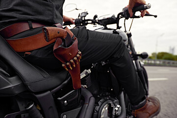 mafia man on bike with handgun. Sporty biker handsome rider male. Chase