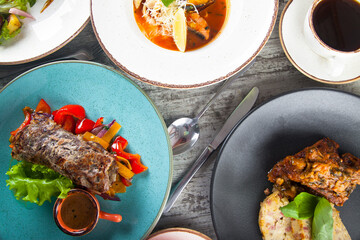 lunch dishes and drinks from above on wooden background