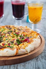 pizza stuffed with tomatoes and cheese on a wooden table