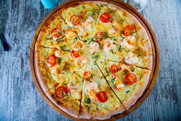 pizza stuffed with tomatoes and cheese on a wooden table