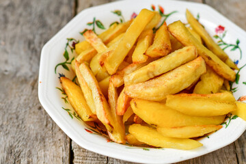  Home made   Fresh fried French fries  in a bowl on wooden rustic  background