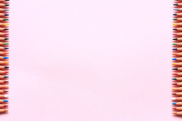 Colored pencils on a colored background. A set of pencils for drawing. Background from pencils.