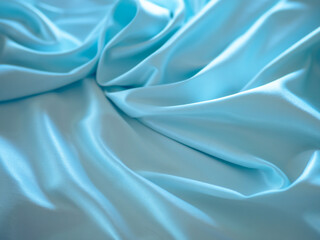Soft fabric with beautiful folds of light color in a blur.