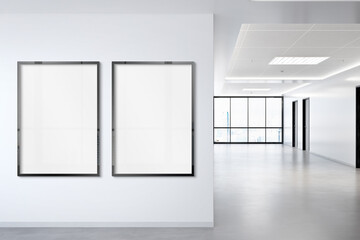 Fototapeta premium Two vertical frames Mockup hanging on wall. Mock up of billboards in modern concrete office interior 3D rendering