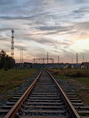 Fototapeta na wymiar beautiful path with rails against the background of an unusual sky
