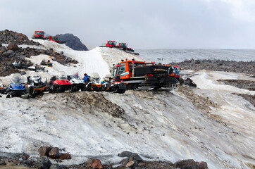 snowplows and snowmobiles on the mountainside
