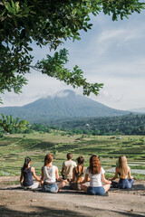 A group of yogis doing yoga, meditating in nature, in the mountains, beautiful view.