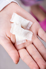 snus. the teenager's hand is in it, tobacco in bags. the background is wooden in a retro style. there is a tinting. close-up.