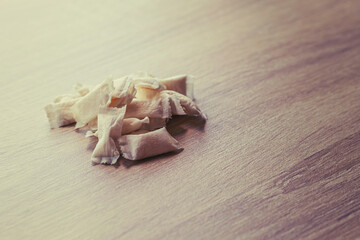 snus. tobacco in bags. the background is wooden in a retro style. there is a tinting. close-up.