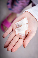 snus. the teenager's hand is in it, tobacco in bags. the background is wooden in a retro style. there is a tinting. close-up.