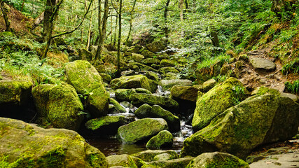 Piles of boulders with water stream running through