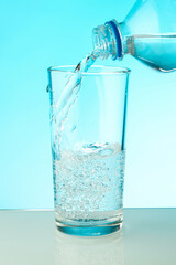 water pouring into a glass close up. filling a glass with clean water from a bottle