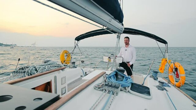 The captain of the yacht who is at the helm and steers the yacht at dinner. Boat trip at dinner.