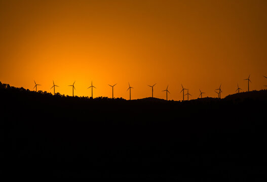 Windmill farm renewable energies wind environment sustainable economy long shot skyline sunset solar energy