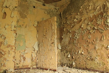 An old door inside of an empty building with peeling paint