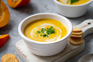 A bowl with delicious orange pumpkin soup. Spicy, vegan vegetable autumn soup.