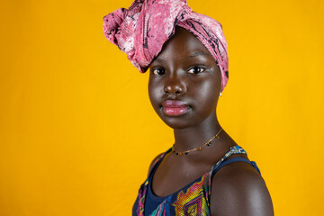 portrait of african female teen with colorful ethnic scarf on head