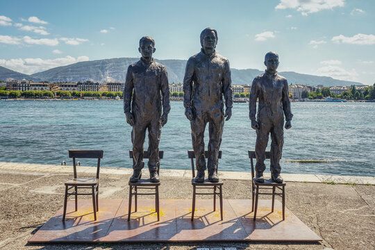 GENEVA, SWITZERLAND - AUGUST 31, 2021: "Anything to say? A monument to courage." Geneva monument honors Snowden, Assange and Manning. Sculptures standing on chairs. Public Art in Geneva.