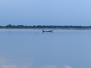 a fishermen fishing alone on the lake