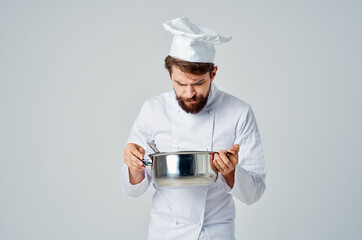 a man in a chef's uniform with a saucepan in his hands tasting food restaurant Professional