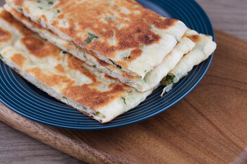 Staple food pasta scallion pie on a plate