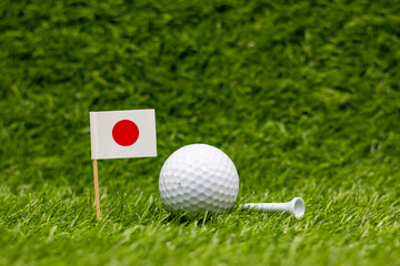 Golf ball with Flag of Japan on green grass