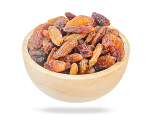 Golden dried raisins in wooden bowl isolated on white background.