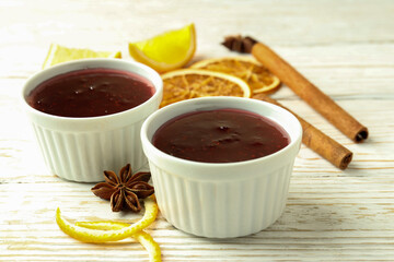 Cranberry sauce and ingredients on white wooden background