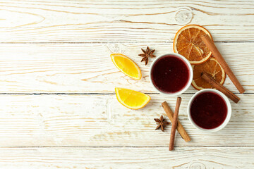 Cranberry sauce and ingredients on white wooden background