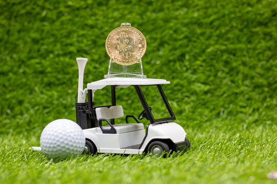 golf cart and bitcoin are on green grass. Bitcoin is a decentralized digital currency, without a central bank or single administrator, that can be sent from user to user on the peer-to-peer bitcoin ne - Powered by Adobe