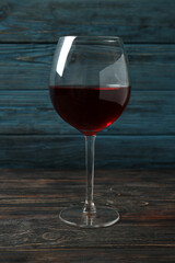 Glass of red wine on rustic wooden background