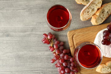 Concept of tasty eating with red wine on gray textured table