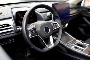 Steering wheel of an electric modern car. Car interior. Driver's seat with steering wheel and...