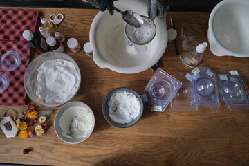 handmade bath bombs process. Preparation of bath bombs. Ingredients and floral decor on a wooden vintage table.
