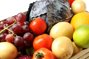 Wooden box with vegetables and fruits, close up