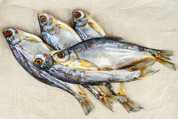 Few cured white-eye bream (Ballerus sapa) fishes on brown paper background