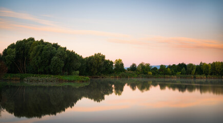 Fototapeta na wymiar Beautiful morning clouds reflected in a small lake in Burgenland