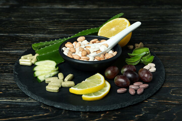 Concept of herb pills on rustic wooden table