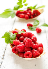 Raspberries in the wooden plates - boats with leaves