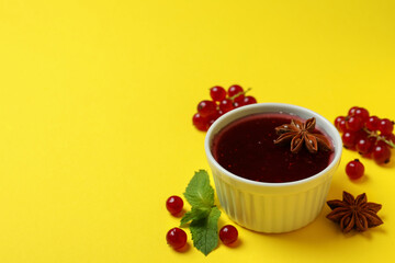 Cranberry sauce and ingredients on yellow background
