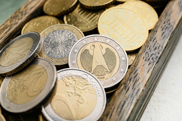 Tray with heap of coins, closeup