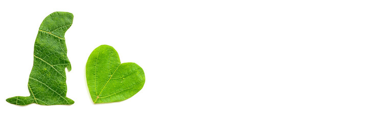 The silhouette of the animal and the heart is carved from green foliage on a white background....