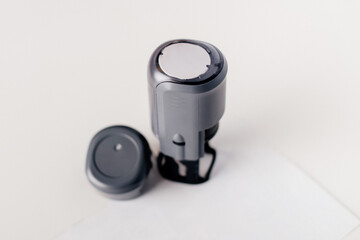 A professional office stamp placed on a white surface, ready for official use.