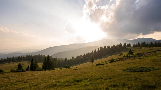 Time lapse at sunset with beautiful moving clouds over the tree-covered mountain slopes, the Rhodopes in Bulgaria