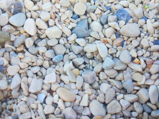 Texture of sea pebbles, dark and light stones 