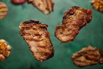 Flying beef brisket on color background