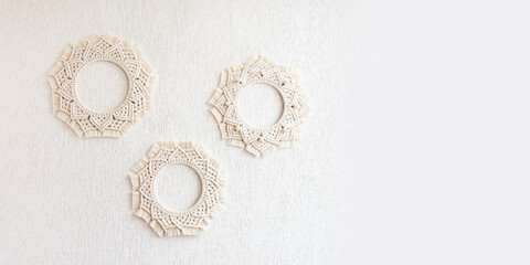Macrame mandalas. Macrame wreathes on a white background. Natural cotton thread. Eco home decor. Soft focus. Copy space