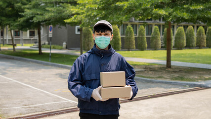 Parcel delivery concept the young sender lifting two boxes of parcels and standing in middle of...